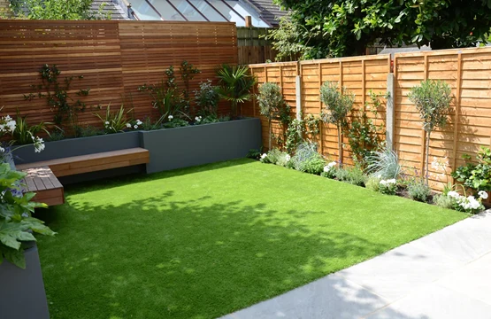 Artificial lawn with timber boundary — JC Style Drives website photograph
