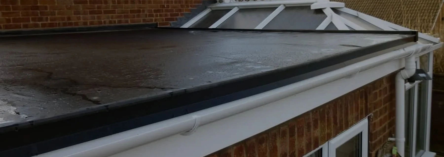 Flat roof perimeter and gutter detail — JC Style Drives website photograph